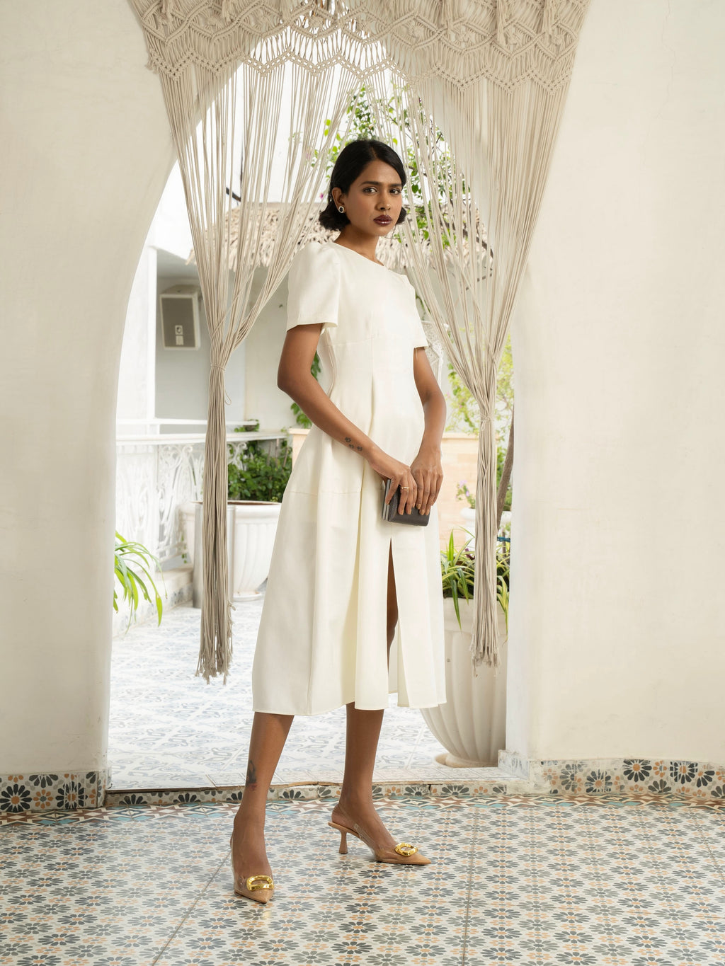 Side view of model wearing Ivory white midi dress with front slit, puffed sleeve-MISSVI