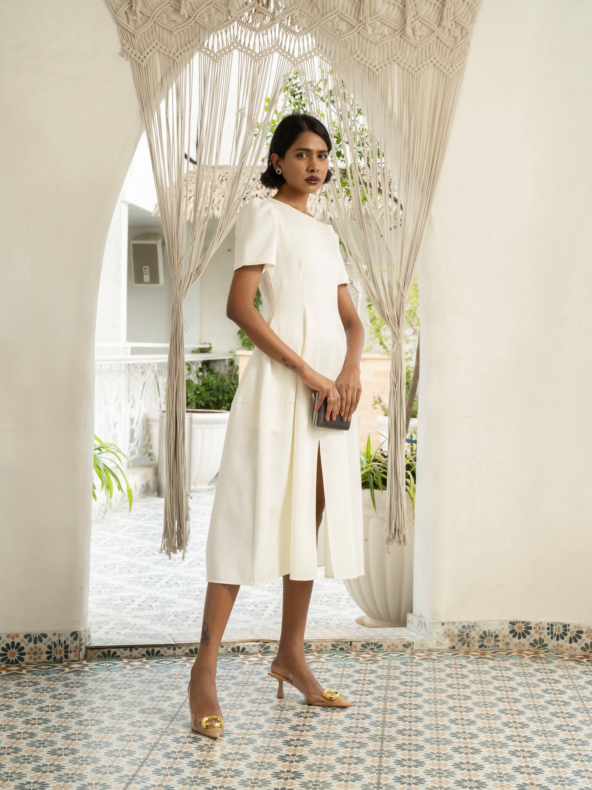 Side view of model wearing Ivory white midi dress with front slit, puffed sleeve-MISSVI