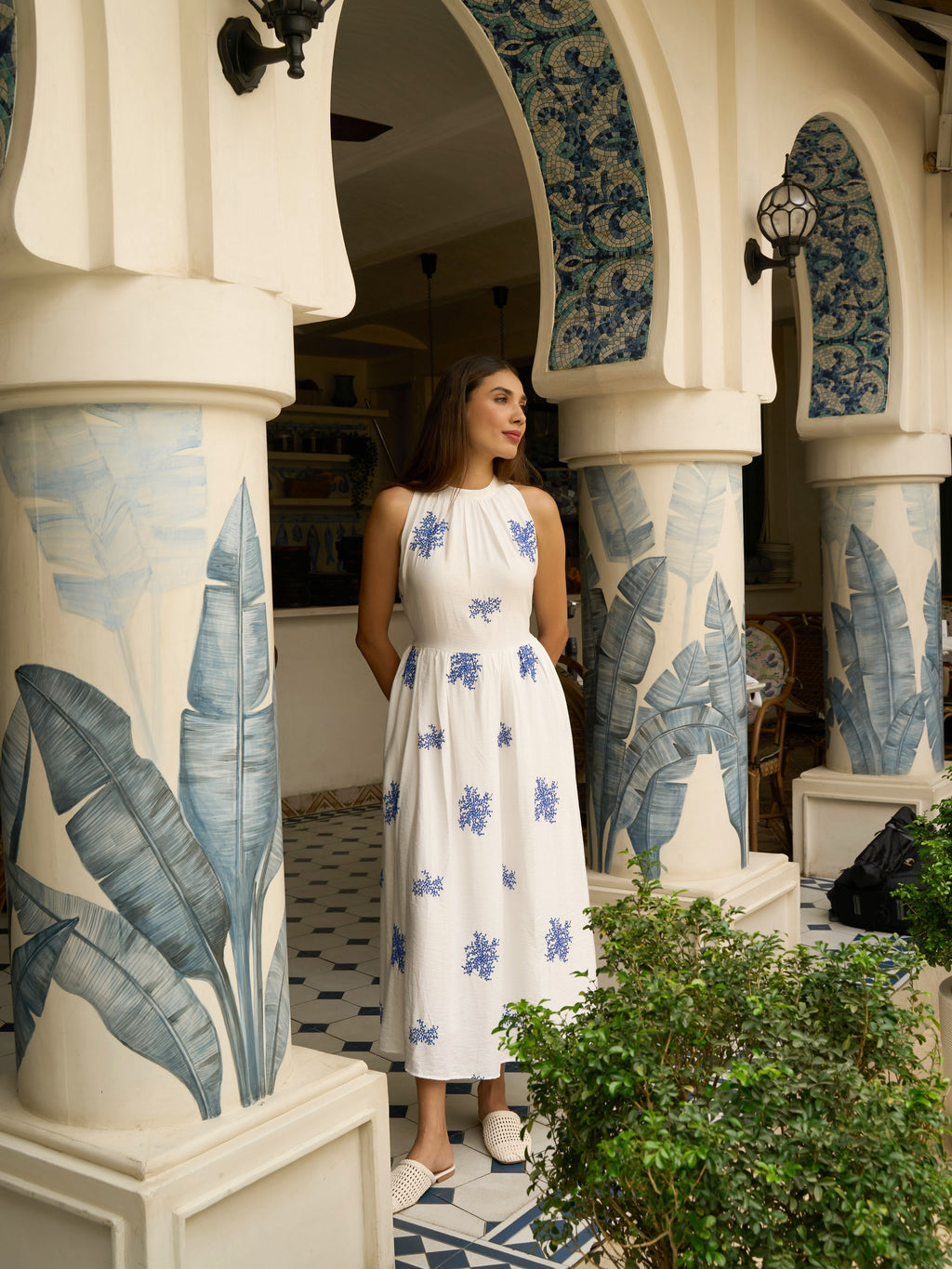 Front view of model wearing Embroidered sleeveless maxi in cotton-silk with halter neck, tie-back waist, and pockets-MISSVI