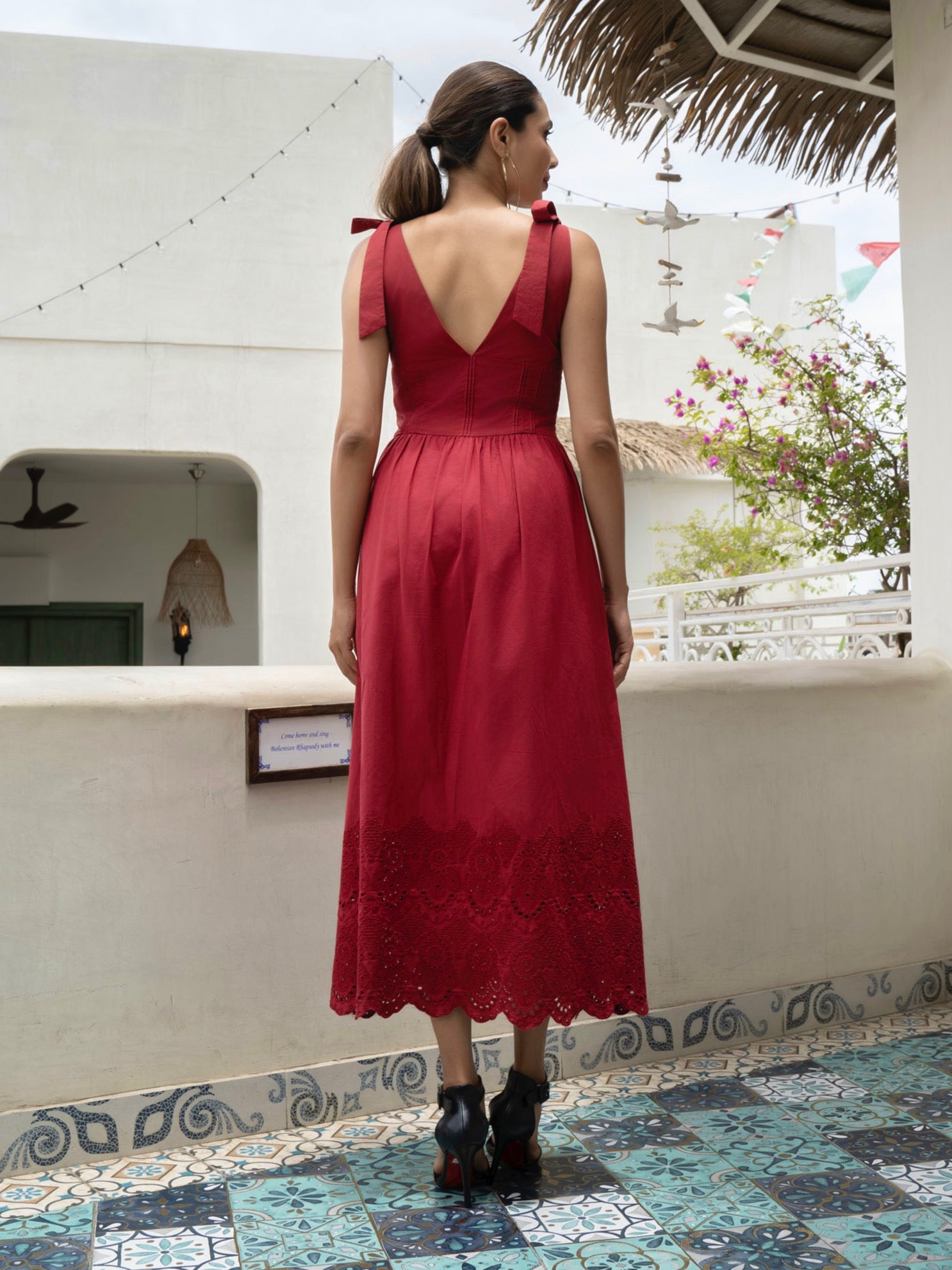 Rear view of model wearing Red Cotton midi dress with tie straps, V-neck, broderie anglaise hem, and pockets-MISSVI