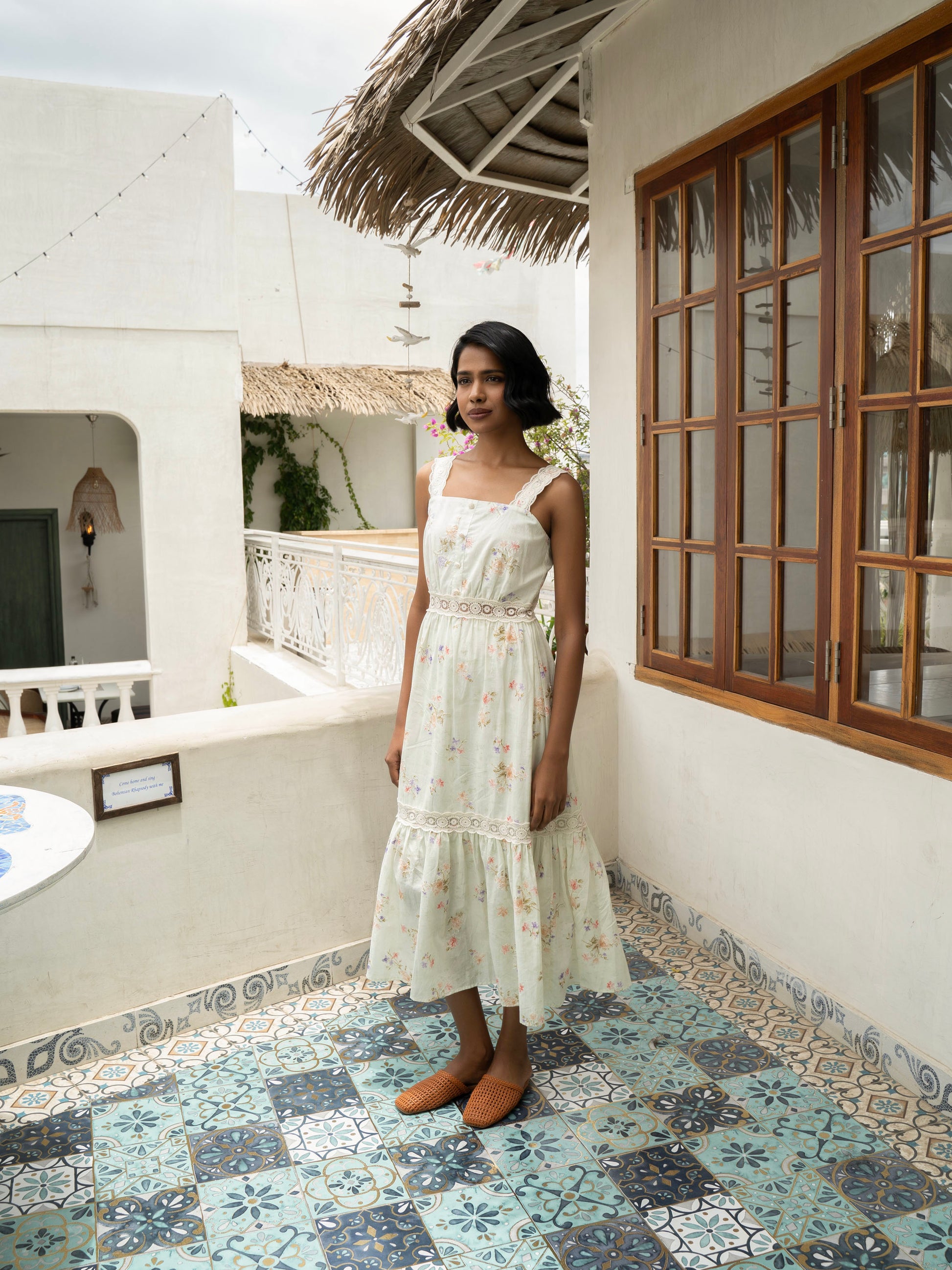Side view of model wearing Pastel floral cotton midi with lace straps and tiered skirt-MISSVI