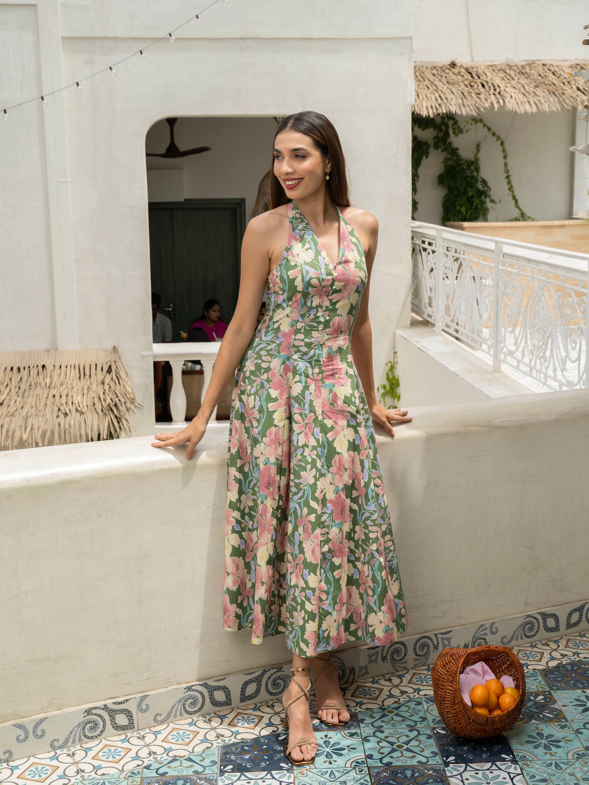 Front view of model wearing Hibiscus floral halter midi with covered buttons, open back, and fit-and-flare silhouette-MISSVI