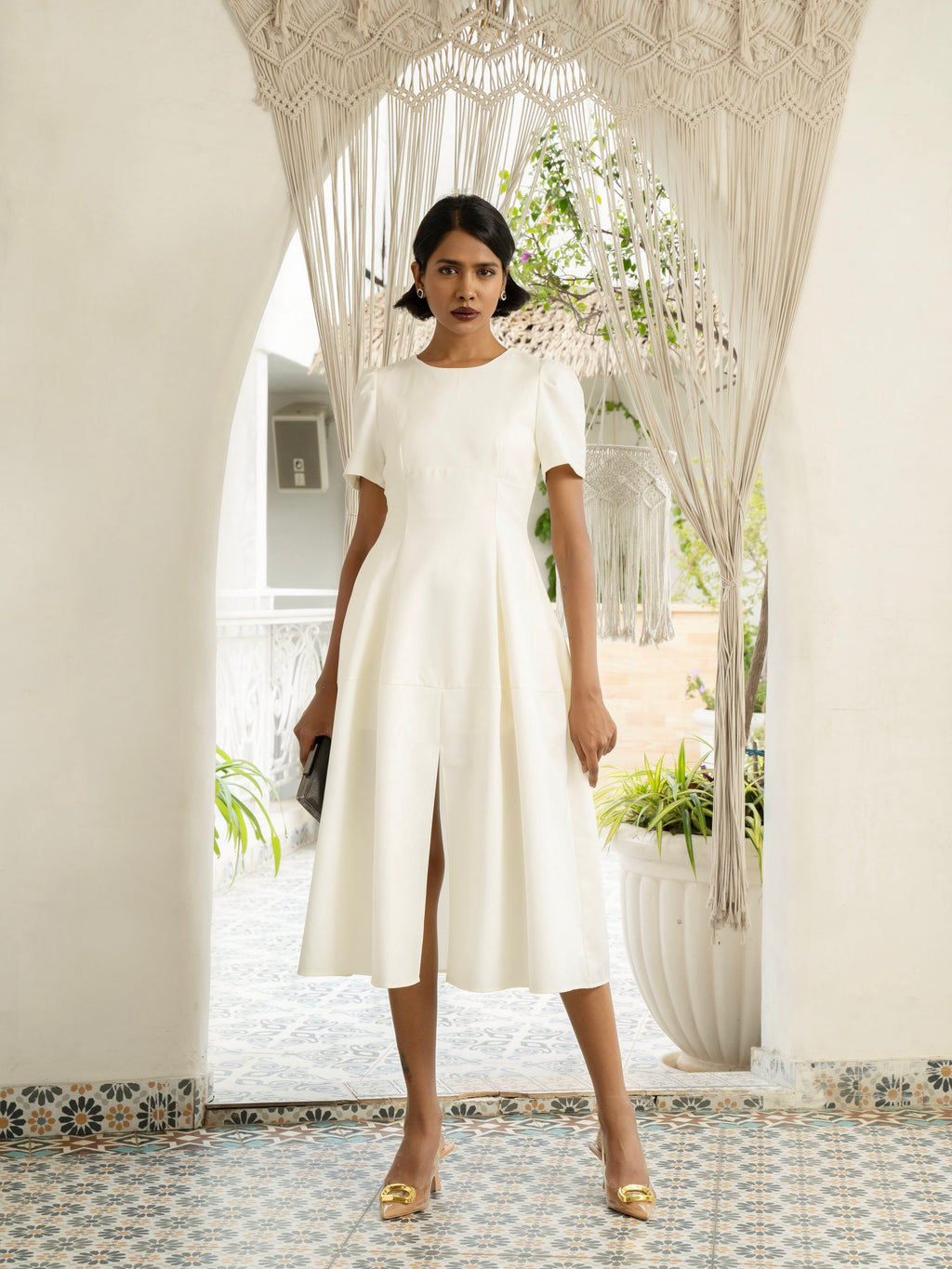 Front view of model wearing Ivory white midi dress with front slit, puffed sleeve-MISSVI
