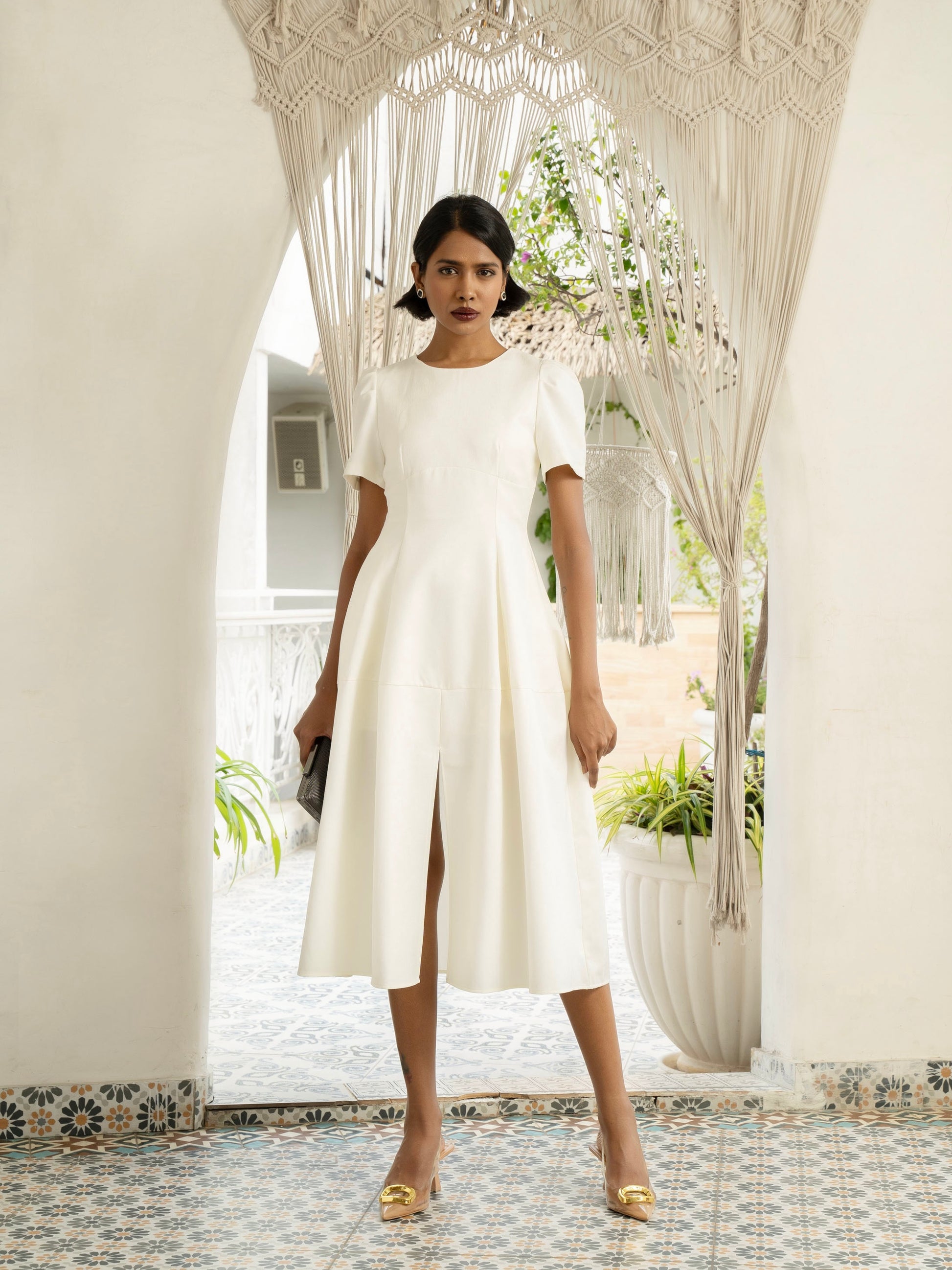Front view of model wearing Ivory white midi dress with front slit, puffed sleeve-MISSVI