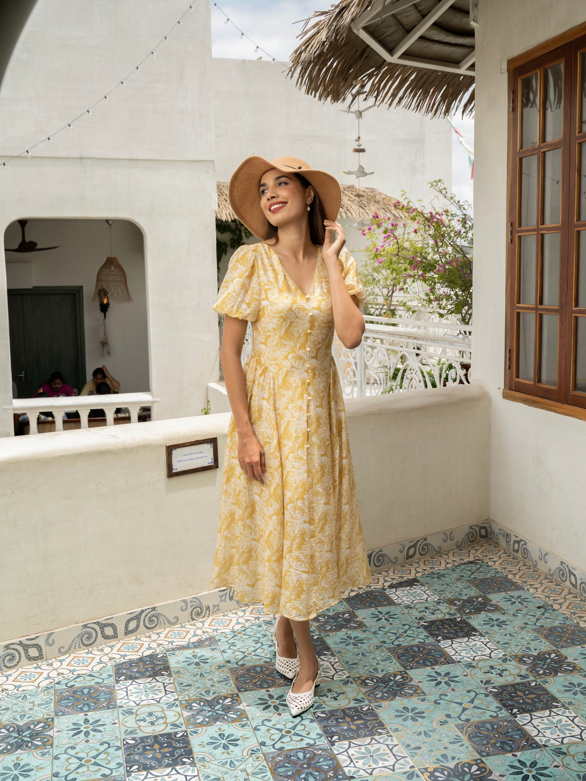 Front view of model wearing yellow Floral fit-and-flare midi with puff sleeves, covered buttons, and V-neckline-MISSVI