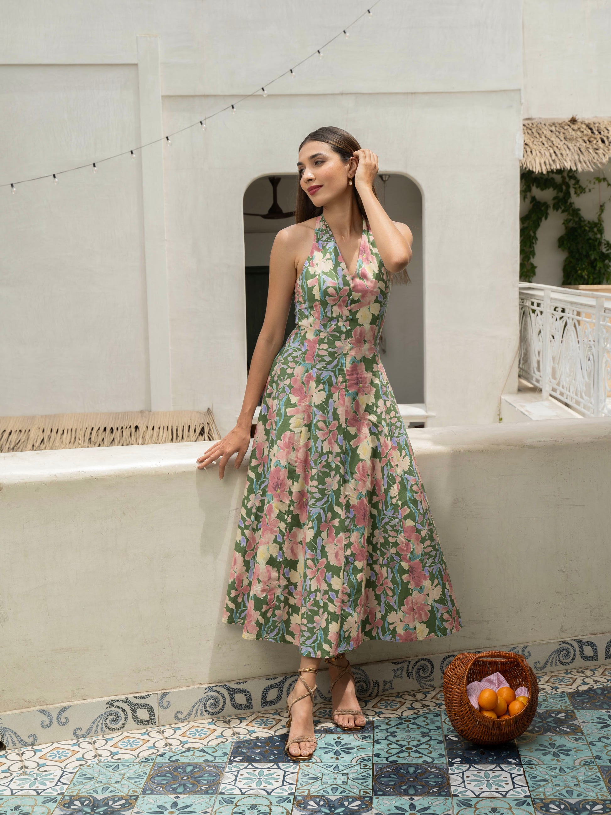Front view of model wearing Hibiscus floral halter midi with covered buttons, open back, and fit-and-flare silhouette-MISSVI