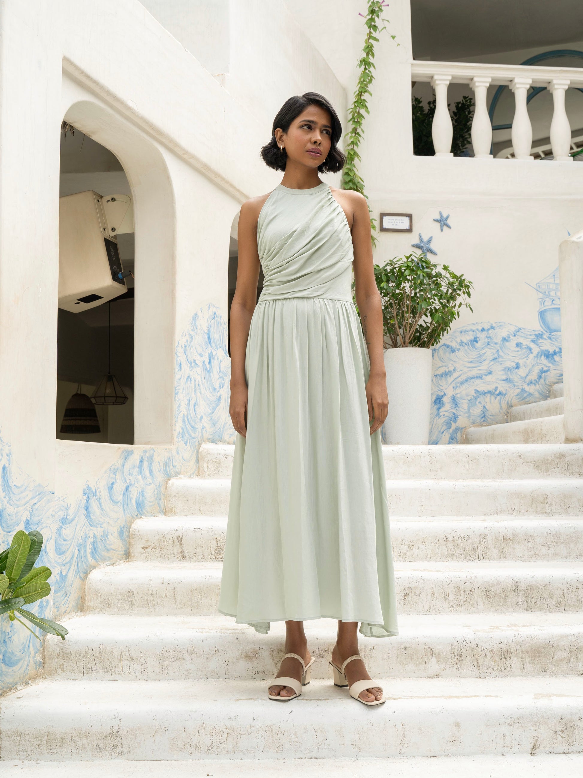 Front view of model wearing Draped halter maxi dress with ruching, asymmetrical hem, and defined waist-MISSVI