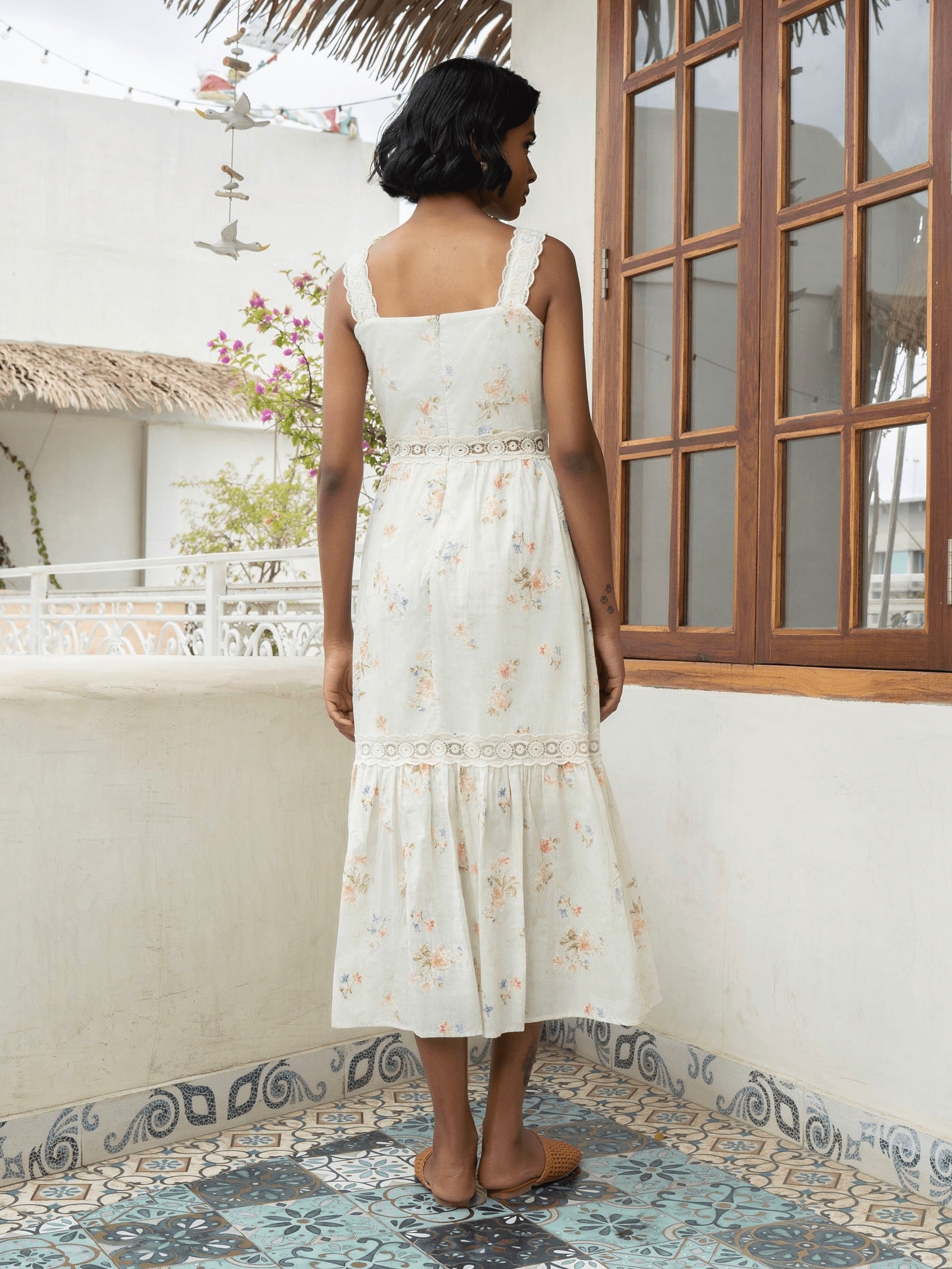 Rear view of model wearing Pastel floral cotton midi with lace straps and tiered skirt-MISSVI